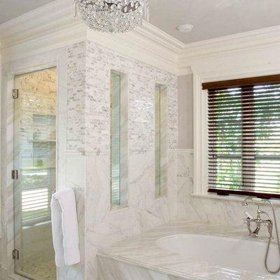 Example of a classic white tile alcove shower design in New York with an undermount tub