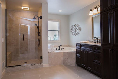 Bathroom - large traditional master beige tile and stone tile vinyl floor and beige floor bathroom idea in Detroit with raised-panel cabinets, dark wood cabinets, a two-piece toilet, white walls, a drop-in sink, granite countertops and beige countertops
