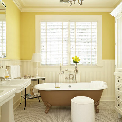 Example of a classic mosaic tile floor claw-foot bathtub design in Atlanta with white cabinets, yellow walls, a pedestal sink and recessed-panel cabinets