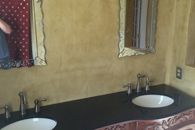 Example of a mid-sized tuscan master beige tile and porcelain tile ceramic tile and beige floor alcove bathtub design in New York with furniture-like cabinets, dark wood cabinets, an undermount sink, quartz countertops and black countertops
