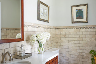 Mid-sized elegant 3/4 beige tile and stone tile ceramic tile and beige floor bathroom photo in Other with shaker cabinets, medium tone wood cabinets, a one-piece toilet, an undermount sink, quartzite countertops and white walls