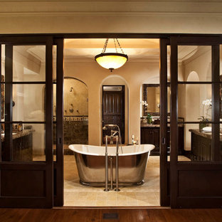 Bathroom - large traditional master ceramic tile bathroom idea in Orange County with dark wood cabinets, beige walls, an undermount sink and granite countertops