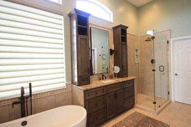 Bathroom - large traditional master beige tile and porcelain tile porcelain tile bathroom idea in Austin with shaker cabinets, dark wood cabinets, green walls, an undermount sink and granite countertops