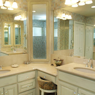 Inspiration for a small transitional master beige tile, blue tile, gray tile, white tile and glass tile marble floor doorless shower remodel in Austin with an undermount sink, raised-panel cabinets, distressed cabinets, multicolored walls, marble countertops and a two-piece toilet