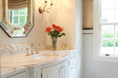 Example of a mid-sized classic master white tile and ceramic tile bathroom design in Other with shaker cabinets, white cabinets, white walls, a drop-in sink and marble countertops