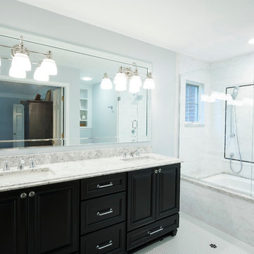Traditional master bathroom with dark cabinets and white Quartz countertop