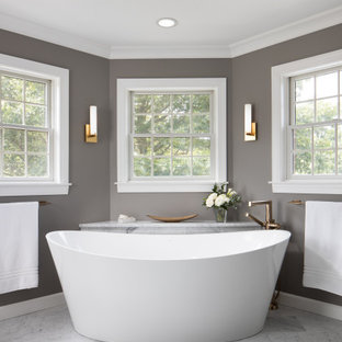 Example of a huge transitional master gray tile and marble tile marble floor, gray floor and single-sink bathroom design in Other with recessed-panel cabinets, dark wood cabinets, a two-piece toilet, gray walls, an undermount sink, granite countertops, white countertops and a freestanding vanity