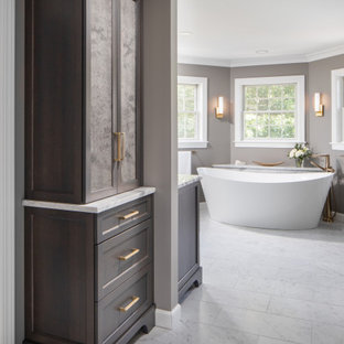 Inspiration for a huge transitional master gray tile and marble tile marble floor, gray floor and single-sink bathroom remodel in Other with recessed-panel cabinets, an undermount sink, granite countertops, a freestanding vanity, dark wood cabinets, a two-piece toilet, gray walls and white countertops