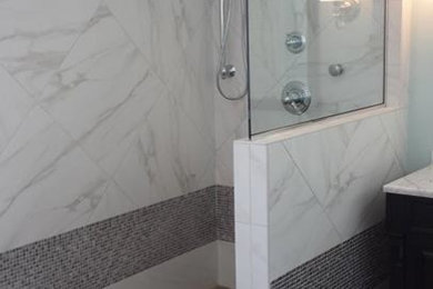 Mid-sized transitional master gray tile and porcelain tile porcelain tile bathroom photo in Chicago with an undermount sink, raised-panel cabinets, dark wood cabinets, marble countertops, a one-piece toilet and blue walls