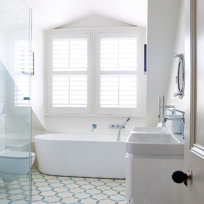Inspiration for a transitional multicolored tile ceramic tile bathroom remodel in London with a trough sink, a two-piece toilet and white walls
