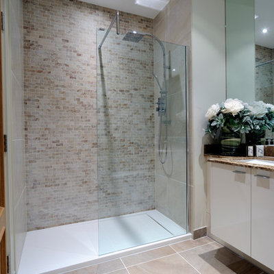 Inspiration for a transitional beige tile and subway tile alcove shower remodel in London with an undermount sink and flat-panel cabinets