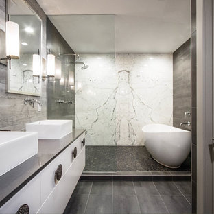 Inspiration for a transitional master gray tile gray floor bathroom remodel in Other with flat-panel cabinets, white cabinets, a vessel sink and gray countertops