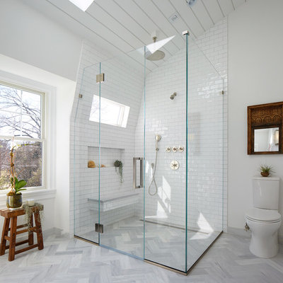 Corner shower - large transitional master white tile and subway tile gray floor and marble floor corner shower idea in New York with a two-piece toilet, white walls, a pedestal sink, flat-panel cabinets, gray cabinets and marble countertops