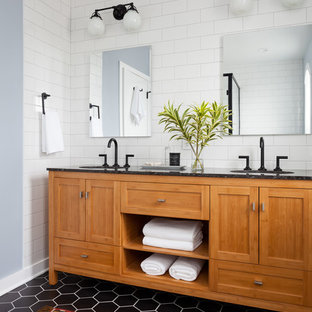 Design ideas for a medium sized classic ensuite bathroom in Seattle with shaker cabinets, medium wood cabinets, black and white tiles, ceramic tiles, grey walls, porcelain flooring, a submerged sink, engineered stone worktops, a corner shower, a one-piece toilet and black floors.