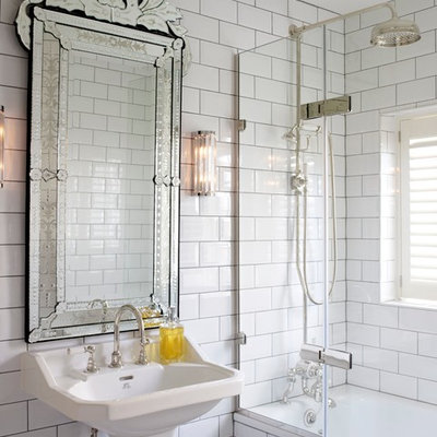 Inspiration for a transitional white tile and subway tile tub/shower combo remodel in London with a pedestal sink and white walls