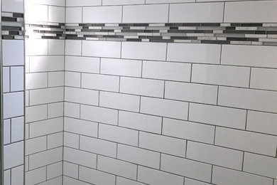 Medium sized traditional ensuite bathroom in Cleveland with an alcove shower, white tiles, metro tiles, white walls, marble flooring and grey floors.