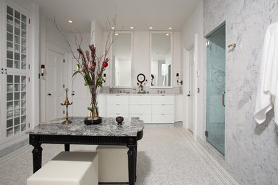 Inspiration for a large transitional master ceramic tile and gray floor alcove shower remodel in DC Metro with flat-panel cabinets, white cabinets, a one-piece toilet, white walls, an undermount sink, an undermount tub, marble countertops and a hinged shower door