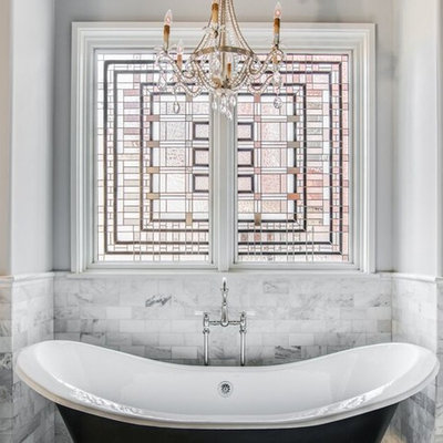 Inspiration for a mid-sized timeless master black and white tile and white tile mosaic tile floor and multicolored floor claw-foot bathtub remodel in Charlotte with white cabinets, gray walls, a one-piece toilet, a vessel sink, marble countertops and recessed-panel cabinets