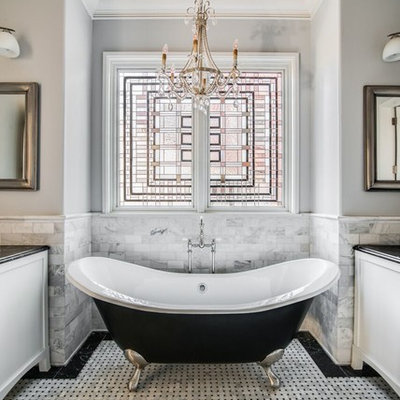 Claw-foot bathtub - mid-sized traditional master black and white tile and white tile mosaic tile floor and multicolored floor claw-foot bathtub idea in Charlotte with white cabinets, gray walls, a one-piece toilet, a vessel sink, marble countertops and recessed-panel cabinets