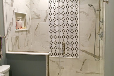 Mid-sized transitional 3/4 black tile and porcelain tile marble floor alcove shower photo in Newark with a two-piece toilet, gray walls and marble countertops