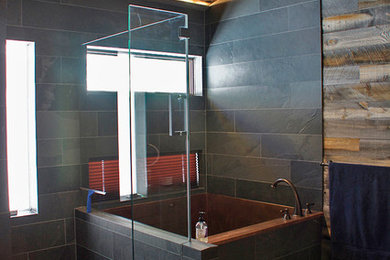 Japanese bathtub - mid-sized rustic master black tile and slate tile brown floor japanese bathtub idea in Denver with gray walls