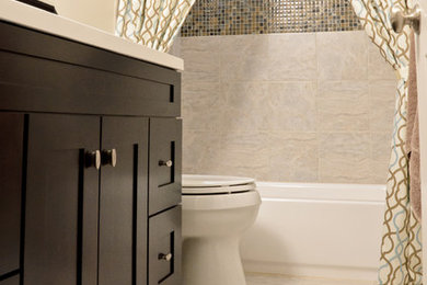 Small transitional beige tile porcelain tile tub/shower combo photo in Chicago with shaker cabinets, dark wood cabinets and beige walls