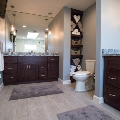Large elegant master gray tile and porcelain tile porcelain tile double shower photo in Cleveland with an undermount sink, shaker cabinets, dark wood cabinets, granite countertops, a two-piece toilet and gray walls