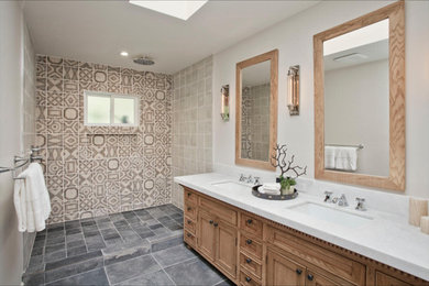 Doorless shower - mid-sized transitional 3/4 beige tile, brown tile, white tile and ceramic tile porcelain tile doorless shower idea in Los Angeles with recessed-panel cabinets, light wood cabinets, a two-piece toilet, beige walls, an undermount sink and quartz countertops
