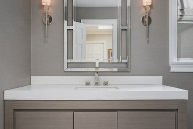 Example of a mid-sized transitional 3/4 white tile and porcelain tile marble floor, gray floor, single-sink and wallpaper alcove shower design in New York with furniture-like cabinets, gray cabinets, a two-piece toilet, gray walls, an undermount sink, quartz countertops, a hinged shower door, white countertops, a niche and a freestanding vanity