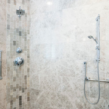 Transitional marble shower with vertical accent band & chrome fixtures