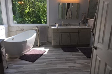 Bathroom - mid-sized transitional master gray tile, white tile and ceramic tile porcelain tile bathroom idea in St Louis with raised-panel cabinets, dark wood cabinets, a one-piece toilet, white walls, a drop-in sink and granite countertops