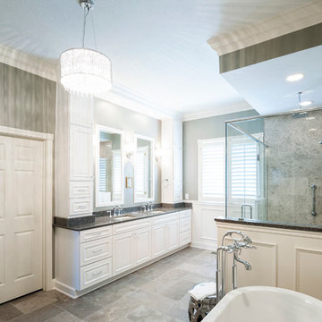 Transitional master bath that features a large double vanity with tower cabinets