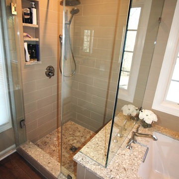 Transitional master bath with wood grain tile floors and quartz tops