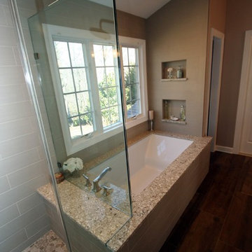 Transitional master bath with wood grain tile floors and quartz tops