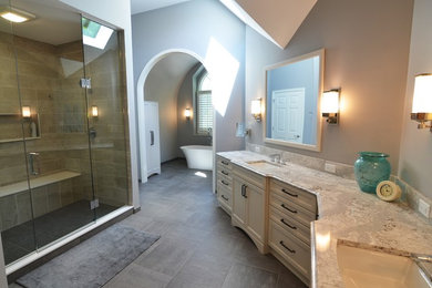 Example of a huge transitional master gray tile and porcelain tile porcelain tile bathroom design in Other with recessed-panel cabinets, white cabinets, a two-piece toilet, gray walls, an undermount sink and quartz countertops