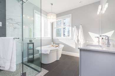 Example of a large transitional master black and white tile and ceramic tile ceramic tile and gray floor bathroom design in Toronto with gray cabinets, gray walls, an undermount sink, granite countertops and a hinged shower door