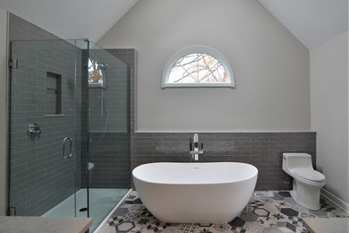 Mid-sized transitional master gray tile and subway tile porcelain tile and multicolored floor bathroom photo in Chicago with flat-panel cabinets, dark wood cabinets, a one-piece toilet, white walls, an undermount sink, quartz countertops and a hinged shower door