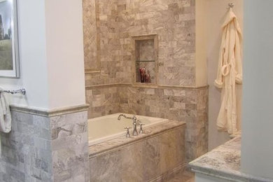 Design ideas for a small mediterranean ensuite bathroom in Cincinnati with shaker cabinets, white cabinets, a built-in bath, a corner shower, a two-piece toilet, grey tiles, stone tiles, travertine flooring, a built-in sink, tiled worktops, beige walls and beige floors.
