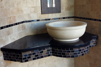 Inspiration for a small mediterranean beige tile and stone tile bathroom remodel in Seattle with a vessel sink and granite countertops