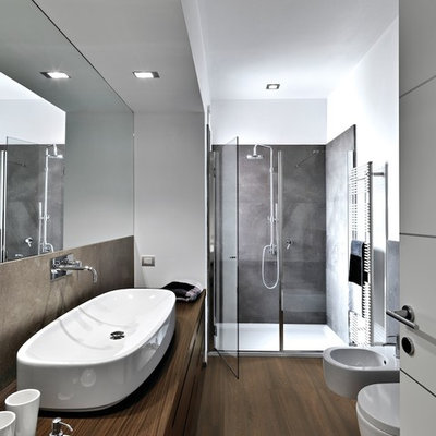 Mid-sized minimalist master vinyl floor alcove shower photo in Philadelphia with flat-panel cabinets, medium tone wood cabinets, a bidet, white walls, a trough sink and wood countertops
