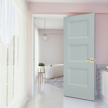 Trendy bathroom with gold accents and light blue door with blush pink walls