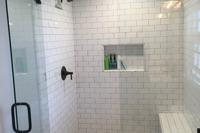This is an example of a medium sized country ensuite bathroom in San Diego with freestanding cabinets, dark wood cabinets, a walk-in shower, a two-piece toilet, white tiles, metro tiles, grey walls, cement flooring, a vessel sink, wooden worktops, multi-coloured floors and a hinged door.