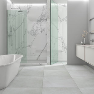 Example of a large trendy master porcelain tile porcelain tile and double-sink bathroom design in Orange County with solid surface countertops and a floating vanity