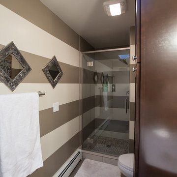 Trick of the eye bathroom remodel! Clear glass shower door makes the room seem m