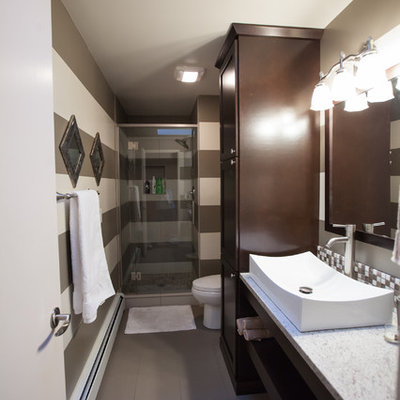 Small eclectic 3/4 multicolored tile and ceramic tile ceramic tile and gray floor alcove shower photo in Seattle with a vessel sink, flat-panel cabinets, dark wood cabinets, granite countertops, a two-piece toilet, multicolored walls, a hinged shower door and gray countertops