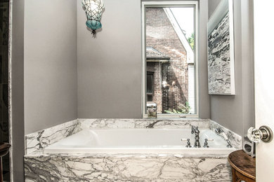 Mid-sized trendy master gray tile drop-in bathtub photo in Toronto with a one-piece toilet and gray walls