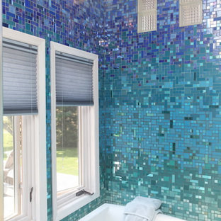 Foto di una grande stanza da bagno padronale tropicale con ante lisce, ante nere, vasca da incasso, piastrelle blu, piastrelle di vetro, pareti blu, lavabo a colonna, top in superficie solida, WC monopezzo, pavimento con piastrelle in ceramica, pavimento beige, doccia aperta e doccia aperta