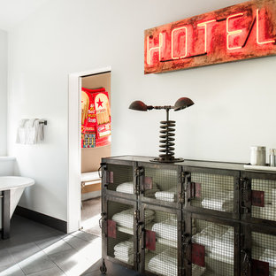 Photo of a large industrial ensuite bathroom in Sacramento with freestanding cabinets, a freestanding bath, white walls, grey tiles, ceramic tiles and porcelain flooring.