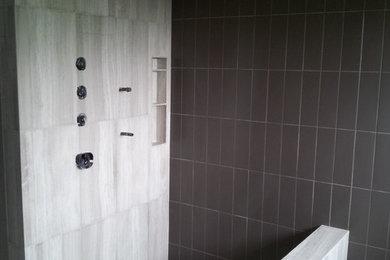 Example of a trendy master gray tile and stone tile doorless shower design in Austin