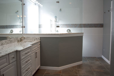 Inspiration for a large transitional master multicolored tile and porcelain tile porcelain tile doorless shower remodel in Dallas with an undermount sink, raised-panel cabinets, white cabinets, quartz countertops and gray walls